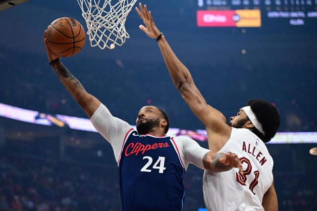 Clippers guard Norman Powell gets to the basket for a layup as Cleveland Cavaliers center Jarrett Allen, right, defends during the first half on Sunday, March 30, 2025, in Cleveland. Powell averaged 21.2 points in his past four games, including a 34-point effort against the Cavs. (AP Photo/David Dermer)