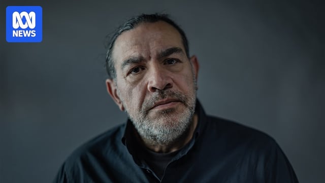 Khaled Sabsabi with serious expression looks into camera, which is very close to his face. He has stubble on his chin, cheeks.