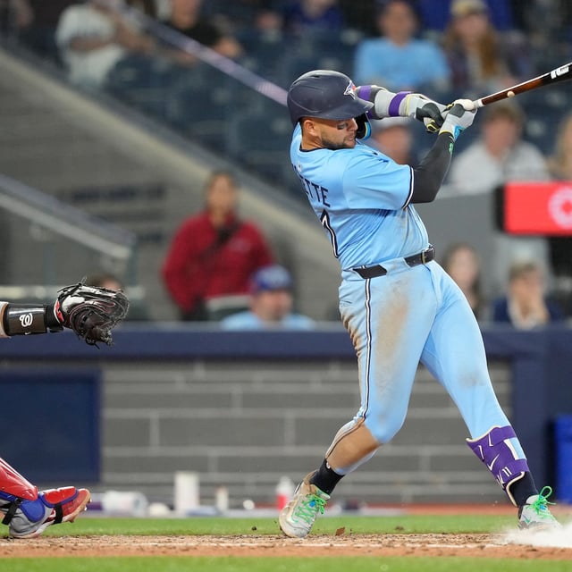 Apr 1, 2025; Toronto, Ontario, CAN; Toronto Blue Jays shortstop Bo Bichette (11) hits a two-run single against the Washington Nationals during the eighth inning at Rogers Centre. Mandatory Credit: John E. Sokolowski-Imagn Images