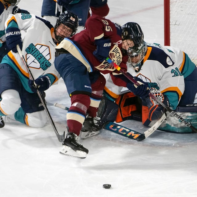 Montreal Victoire's Lina Ljungblom (25) gets in the face of New York Sirens goalie Corinne Schroeder (30) as she tries to score during second period PWHL hockey action in Laval, Que., Tuesday, April 1, 2025. THE CANADIAN PRESS/Peter McCabe