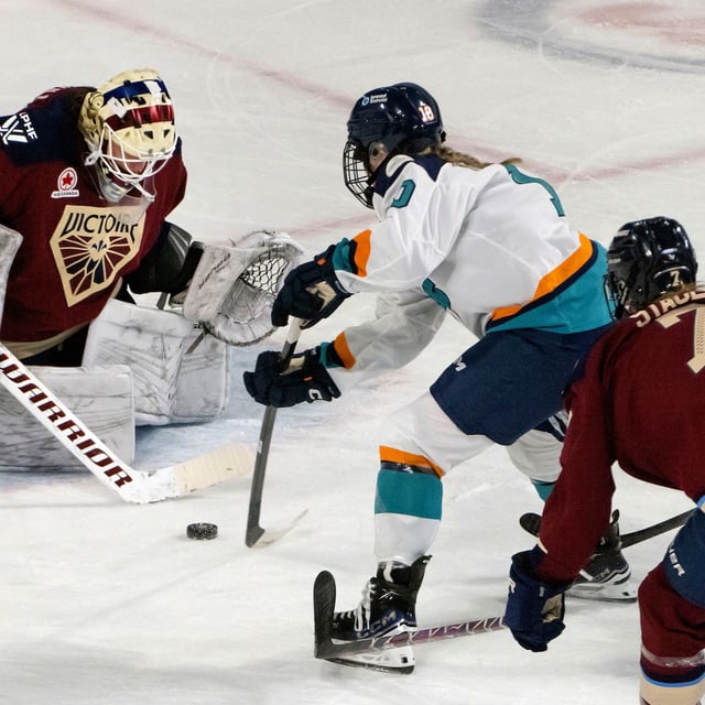 New York Sirens' Sarah Fillier (10) takes the puck to Montreal Victoire goalie Elaine Chuli (20) during second period PWHL hockey action in Laval, Que., Tuesday, April 1, 2025. THE CANADIAN PRESS/Peter McCabe