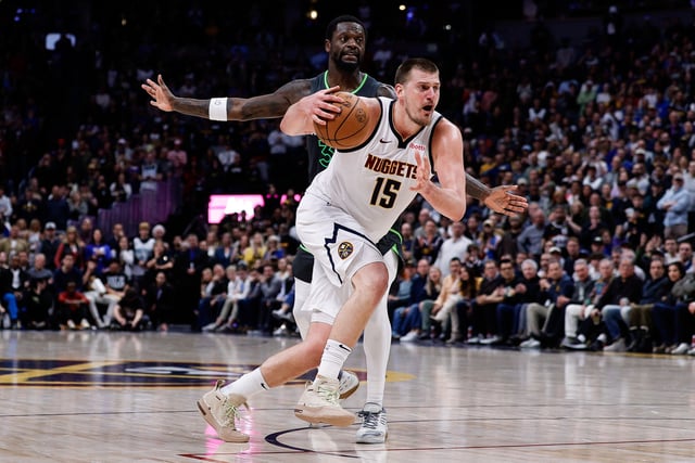 Apr 1, 2025; Denver, Colorado, USA; Denver Nuggets center Nikola Jokic (15) drives to the basket against Minnesota Timberwolves forward Julius Randle (30) in the fourth quarter at Ball Arena. Mandatory Credit: Isaiah J. Downing-Imagn Images