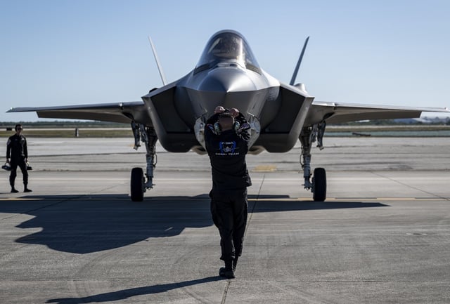 U.S. Air Force Staff Sgt. Jacob Sackett, a dedicated crew chief assigned to the F-35A Demonstration Team, marshals an F-35A Lightning II after it lands for the Southernmost Airshow Spectacular at Naval Air Station Key West, Florida, on March 27