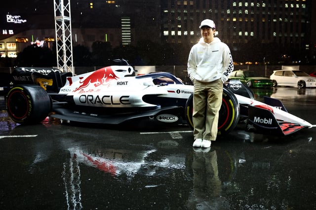 Formula One F1 - Red Bull Car Culture meet ahead of the Japanese Grand Prix - Tokyo, Japan - April 1, 2025 Red Bull's Yuki Tsunoda poses infront of the car during the event REUTERS/Issei Kato