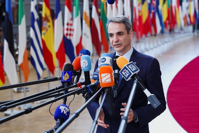 Greek Prime Minister Kyriakos Mitsotakis talks to the press as he attends a European Union summit in Brussels, Belgium March 20, 2025. REUTERS/Yves Herman/File Photo