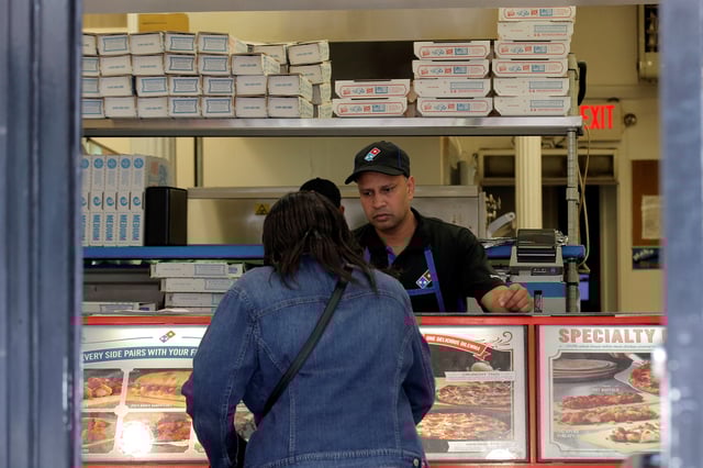 A customer makes an order at a Domino's Pizza restaurant in New York City, U.S., May 25, 2016.  REUTERS/Brendan McDermid/File Photo