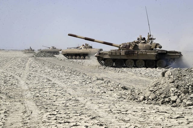 In this photo provided Saturday, Feb. 22, 2025, by the Iranian Army, tanks move forward during a drill in southeastern Iran.