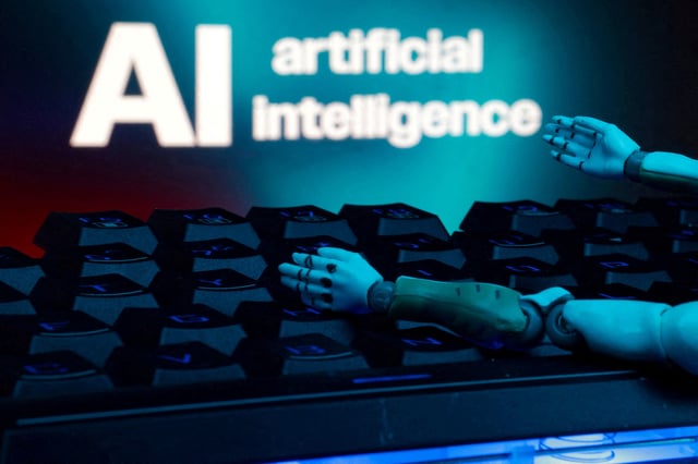 A message reading "AI artificial intelligence", a keyboard, and robot hands are seen in this illustration taken January 27, 2025. REUTERS/Dado Ruvic/Illustration/File Photo