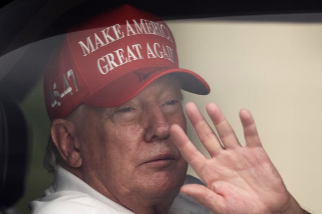 President Donald Trump waves to supporters from his limousine as he arrives at Trump International Golf Club, Saturday, March 29, 2025, in West Palm Beach, Fla.