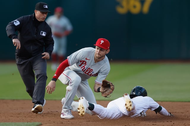 Esteury Ruiz #1 of the Oakland Athletics steals second base ahead of a tag from Trea Turner #7 of the Philadelphia Phillies in the bottom of the third inning at RingCentral Coliseum on June 16, 2023 in Oakland.