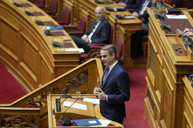Greece's Prime Minister Kyriakos Mitsotakis speaks during a presentation of military spending plans, at the Greek Parliament, in Athens, Wednesday, April 2, 2025. (AP Photo/Petros Giannakouris)
