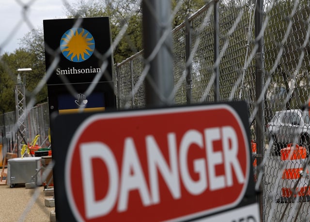 Construction fencing surrounds the Smithsonian Institution Building on the National Mall on March 28, in Washington, DC.
