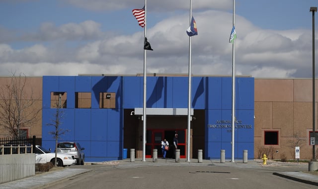 FILE - Visitors walk out of the GEO Detention Center, April 3, 2020, in Aurora, Colo. (AP Photo/David Zalubowski, file)