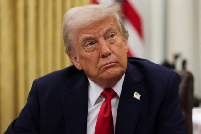 U.S. President Donald Trump prepates to sign an executive order related to the U.S. live entertainment ticketing industry in the Oval Office at the White House in Washington, D.C., March 31, 2025.   REUTERS/Leah Millis/File Photo