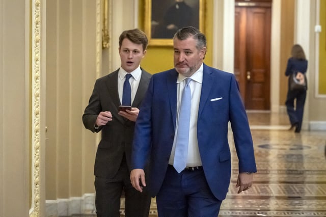 Sen. Ted Cruz, R-Texas, walks to the Senate chamber as the Senate works to avert a partial government shutdown ahead of the midnight deadline, at the Capitol in Washington, Friday, March 14, 2025. (AP Photo/Ben Curtis)