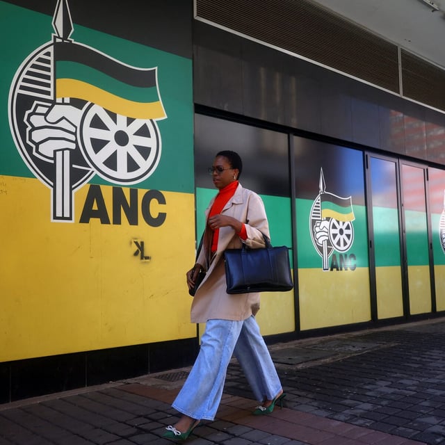 A woman walks past a logo of The African National Congress, at Luthuli House, the ANC headquarters in Johannesburg, South Africa, June 5, 2024. REUTERS/Siphiwe Sibeko