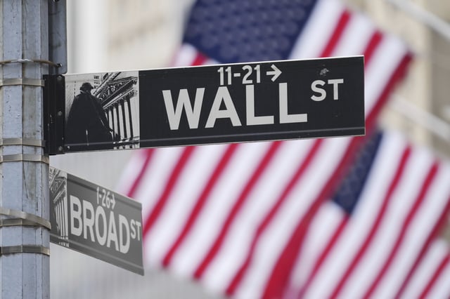 Wall Street signs are displayed outside the New York Stock Exchange in New York, Wednesday, April 2, 2025. (AP Photo/Seth Wenig)