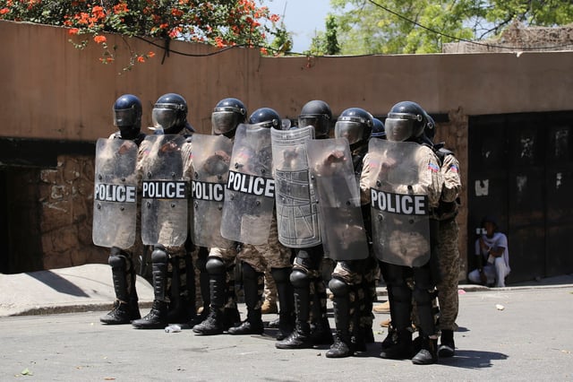 Police officers stand guard during a protest against insecurity, in the Bourdon neighborhood of Port-au-Prince, Haiti April 2, 2025. REUTERS/Jean Feguens Regala