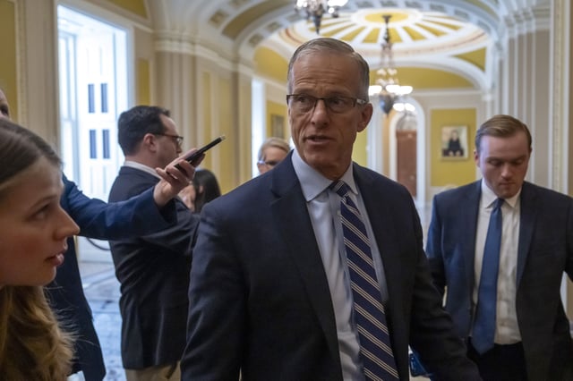 Senate Majority Leader Sen. John Thune, R-S.D., walks to the Senate chamber as the Senate works to avert a partial government shutdown ahead of the midnight deadline, at the Capitol in Washington, Friday, March 14, 2025. (AP Photo/Ben Curtis)