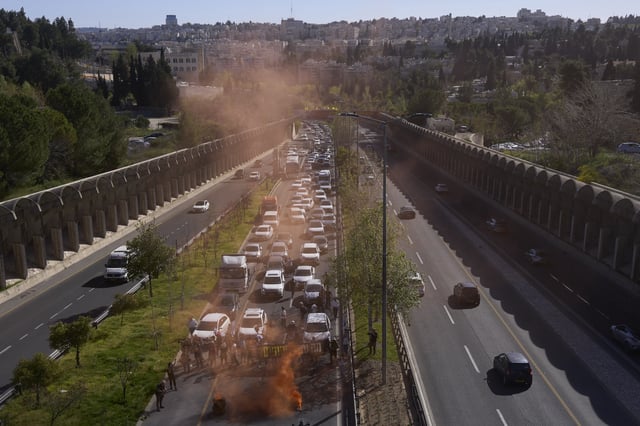 Israelis block a highway in Jerusalem to protest Prime Minister Benjamin Netanyahu's government and demand the release of the hostages held by Hamas in the Gaza Strip, Monday, March 31, 2025. (AP Photo/Ohad Zwigenberg)