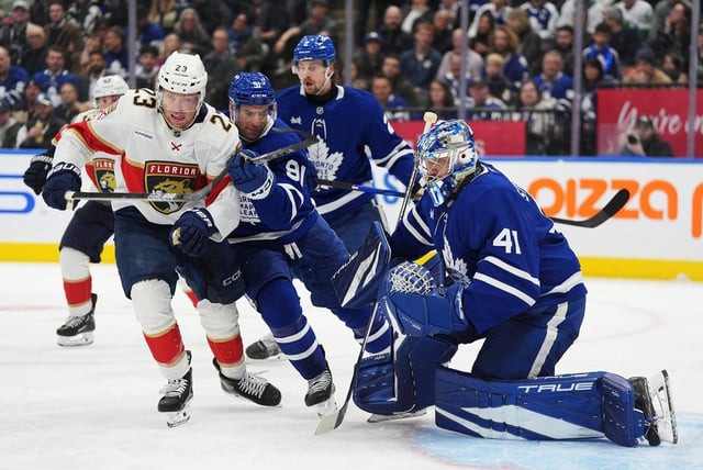 Toronto Maple Leafs goaltender Anthony Stolarz (41) watches the play as Florida Panthers' Carter Verhaeghe (23) battles with Maple Leafs' John Tavares (91) during third period NHL hockey action in Toronto on Wednesday, April 2, 2025. THE CANADIAN PRESS/Frank Gunn