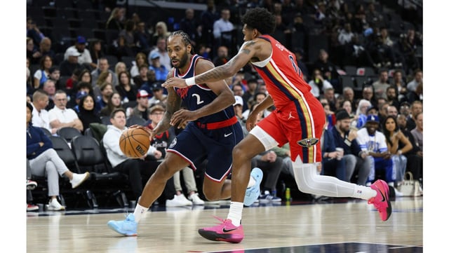 Clippers star Kawhi Leonard, left, drives past New Orleans Pelicans forward Keion Brooks Jr. during the first half on Wednesday night at the Intuit Dome in Inglewood. Leonard had a game-high 28 points in a 114-98 win. (AP Photo/William Liang)