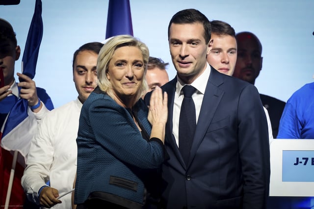 FILE - Leader of the French far-right National Rally Marine Le Pen, left, and Jordan Bardella, lead candidate of the party for the upcoming European election, right, are seen during a political meeting on June 2, 2024, in Paris. (AP Photo/Thomas Padilla, File)