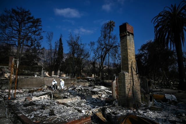 US Environmental Protection Agency contractors remove hazardous waste as they search homes damaged and destroyed by the Eaton Fire in California