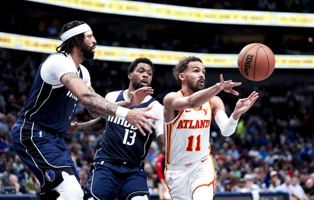 Apr 2, 2025; Dallas, Texas, USA; Atlanta Hawks guard Trae Young (11) passes the ball as Dallas Mavericks forward Naji Marshall (13) and Dallas Mavericks forward Anthony Davis (3) defend during the fourth quarter at American Airlines Center. Mandatory Credit: Kevin Jairaj-Imagn Images