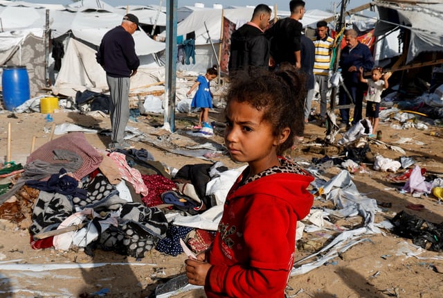 A Palestinian child looks on at the site of an Israeli strike on a tent site housing displaced people, in Khan Younis, in the southern Gaza Strip, April 3, 2025. REUTERS/Hatem Khaled