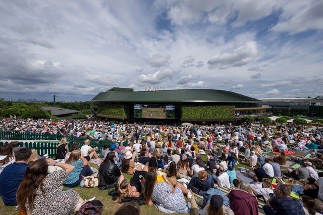 Tennis - Wimbledon - All England Lawn Tennis and Croquet Club, London, Britain - July 11, 2021   Spectators watch the men's final on a large screen as they sit on Henman Hill Pool via REUTERS/Andrew Baker