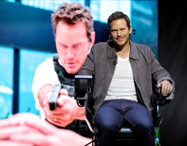 Chris Pratt sits in a prop "execution" chair from his upcoming film "Mercy" at Amazon MGM Studios' CinemaCon presentation.