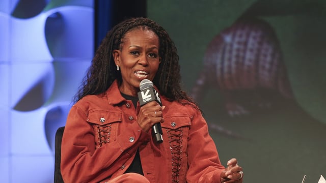 Former first lady Michelle Obama takes part in a featured session and taping of her new podcast, IMO, with her brother Craig Robinson, not pictured, at the Austin Convention Center during the South by Southwest Conference and Festival on Thursday, March 13, 2025, in Austin, Texas. (Photo by Jack Plunkett/Invision/AP)