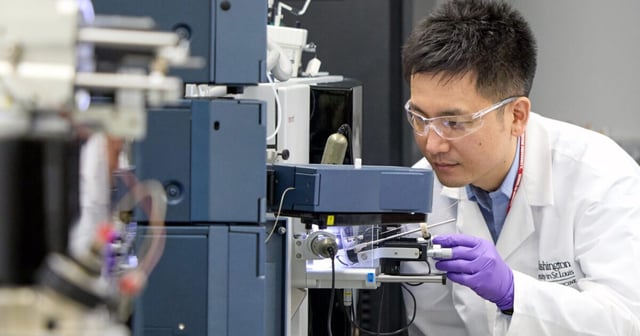 Researcher Kanta Horie from Washington University analyzes a blood sample using a mass spectrometer that measures protein levels