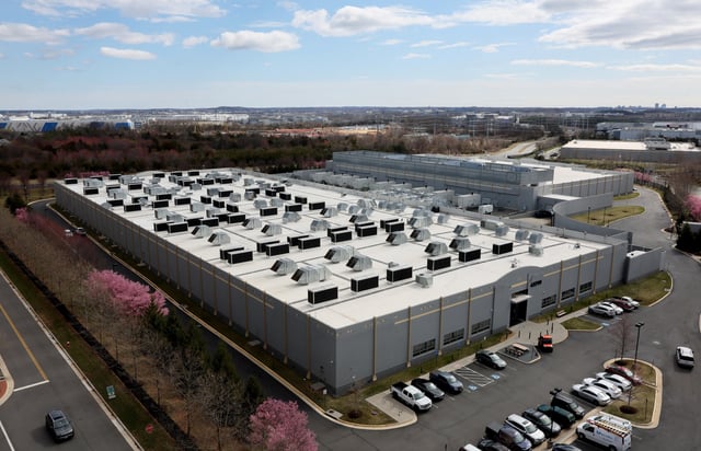 A car drives past a building of the Digital Reality Data Center in Ashburn, Virginia, U.S., March 17, 2025. REUTERS/Leah Millis/File Photo