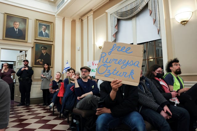 Demonstrators attend a city council meeting after Tufts PhD student Rumeysa Ozturk was taken into custody by federal agents, in Somerville, Massachusetts, U.S. March 27, 2025.  REUTERS/Reba Saldanha/File Photo