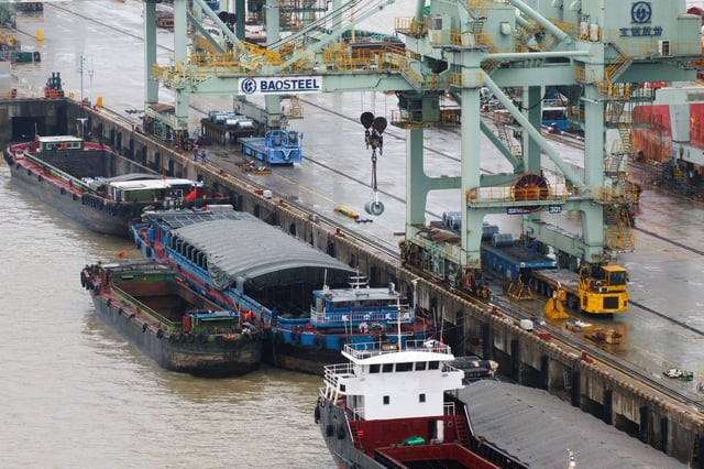 A crane transports steel coil at a port under Baosteel Group, in Baoshan district of Shanghai, China March 13, 2025. China Daily via REUTERS/File Photo