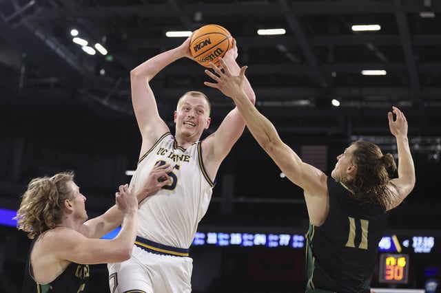 Bent Leuchten #15 of the UC Irvine Anteaters secures a rebound against Mac Riniker #2 and Owen Koonce #11 of the Cal Poly Mustangs in the second half of a semifinal game of the Big West men’s basketball tournament at Lee&#39;s Family Forum on March 14, 2025 in Henderson, Nevada.