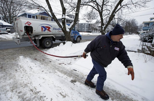 FILE - Paul Dorion, a driver for the Downeast Energy, delivers heating oil to a home in Portland, Maine, Jan. 14, 2015. (AP Photo/Robert F. Bukaty, File)