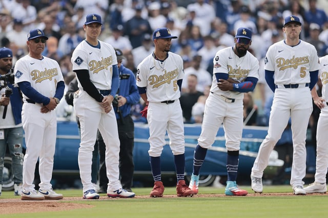 LOS ANGELES, CALIFORNIA - MARCH 27: Manager Dave Roberts #30, Shohei Ohtani #17, Mookie Betts #50 Teoscar Hernández #37 and Freddie Freeman #5 of the Los Angeles Dodgers stand during the National Anthem before the game against the Detroit Tigers on Opening Day at Dodger Stadium on March 27, 2025 in Los Angeles, California.