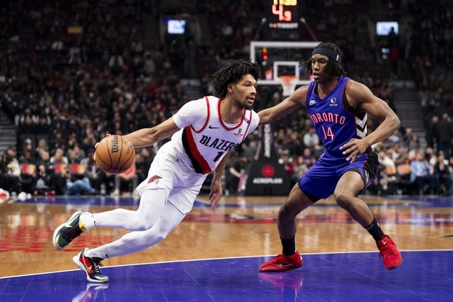 Portland Trail Blazers guard Shaedon Sharpe (17) drives the ball past Toronto Raptors guard Ja'Kobe Walter (14) during the first half of NBA basketball action in Toronto on Thursday April 3, 2025. THE CANADIAN PRESS/Thomas Skrlj
