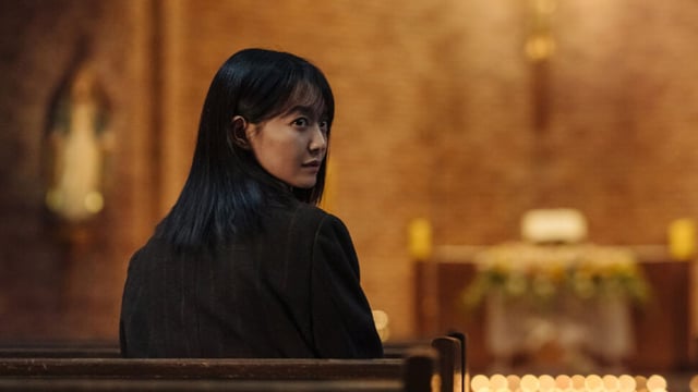 Karma character sitting in a church.