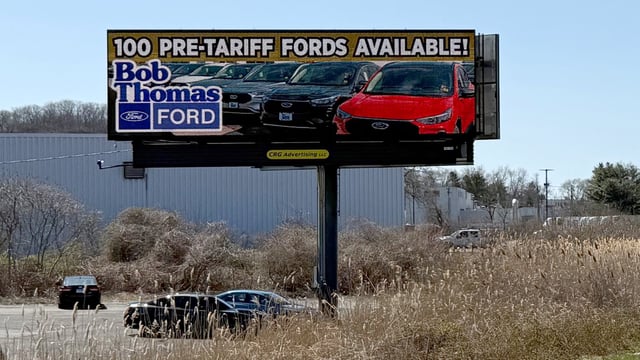 A sign advertising Ford vehicles for sale before any potential tariffs take effect stands by the side of a highway in North Haven, Connecticut, U.S. April 1, 2025. Mel Yu/Handout via REUTERS.