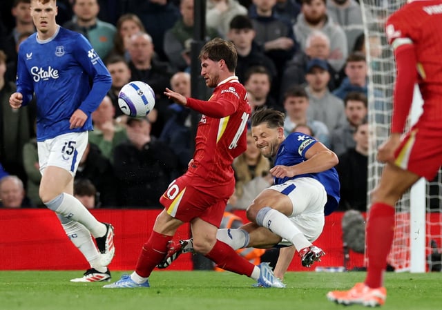 Soccer Football - Premier League - Liverpool v Everton - Anfield, Liverpool, Britain - April 2, 2025 Everton's James Tarkowski fouls Liverpool's Alexis Mac Allister REUTERS/Phil Noble EDITORIAL USE ONLY. NO USE WITH UNAUTHORIZED AUDIO, VIDEO, DATA, FIXTURE LISTS, CLUB/LEAGUE LOGOS OR 'LIVE' SERVICES. ONLINE IN-MATCH USE LIMITED TO 120 IMAGES, NO VIDEO EMULATION. NO USE IN BETTING, GAMES OR SINGLE CLUB/LEAGUE/PLAYER PUBLICATIONS. PLEASE CONTACT YOUR ACCOUNT REPRESENTATIVE FOR FURTHER DETAILS..
