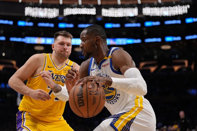 LOS ANGELES, CALIFORNIA - APRIL 03: Jonathan Kuminga #00 of the Golden State Warriors drives against Luka Doncic #77 of the Los Angeles Lakers during the second half of a game at Crypto.com Arena on April 03, 2025 in Los Angeles, California. NOTE TO USER: User expressly acknowledges and agrees that, by downloading and or using this photograph, User is consenting to the terms and conditions of the Getty Images License Agreement. (Photo by Michael Owens/Getty Images)