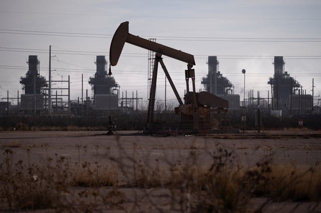 A pump jack operates near a gas turbine power plant in the Permian Basin oil field outside of Odessa, Texas, U.S. February 18, 2025.  REUTERS/Eli Hartman/File Photo