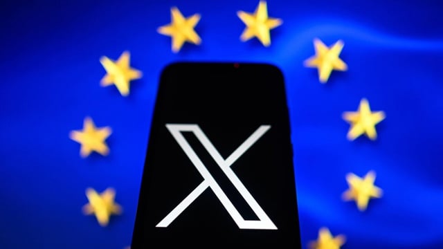 In this photo illustration an X logo is displayed on a smartphone with the European Union flag in the background.