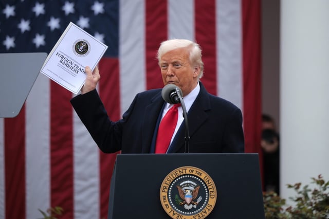 U.S. President Donald Trump holds up a copy of a 2025 National Trade Estimate Report as he speaks during a &#34;Make America Wealth Again&#34; trade announcement event in the Rose Garden at the White House on April 2, 2025 in Washington D.C.