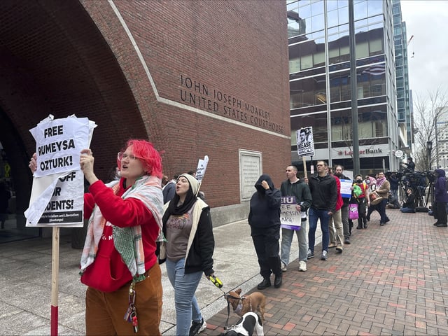 Protesters march outside a federal court, Thursday, April 3, 2025, where a hearing took place for a Tufts University doctoral student detained by immigration authorities on March 25, in Boston. (AP Photos/Michael Casey)