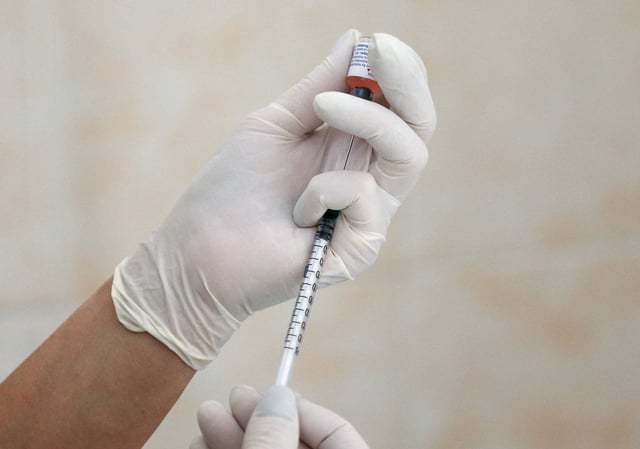 A nurse fills a syringe with a vaccine before administering an injection at a children's clinic in Kiev, Ukraine Aug. 14, 2019. Picture taken August 14, 2019.